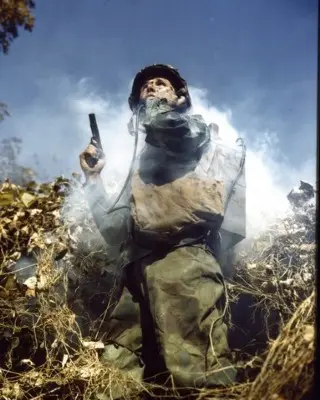 U.S. Marine armed with a 1911 pistol calls in artillery during World War 2.